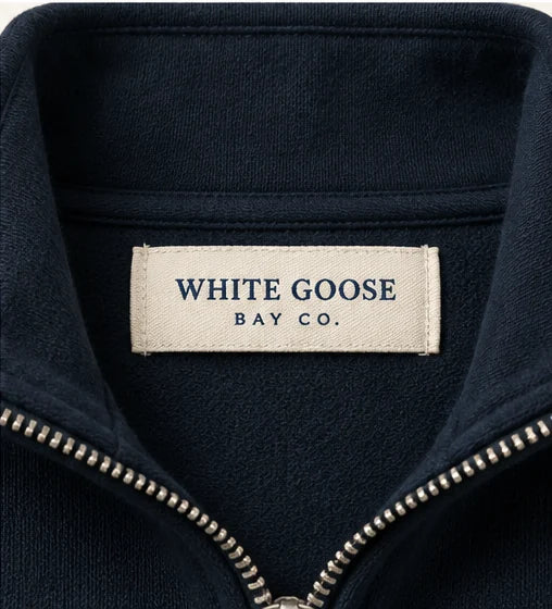 White Goose Bay woven neck label on navy quarter-zip